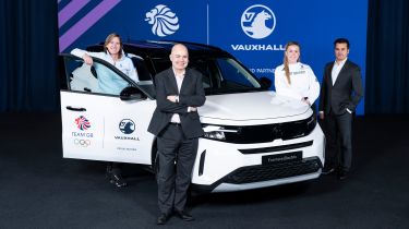 Team GB and Vauxhall representatives stood around a Vauxhall Frontera Electric