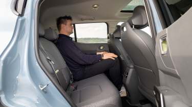 Alastair Crooks sat in the Kia EV2