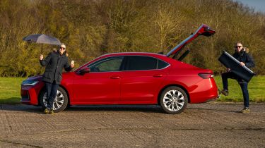 Auto Express senior photographer Pete Gibson standing by the Skoda Superb