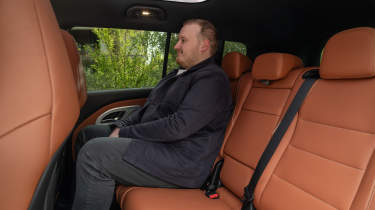 Auto Express news reporter Ellis Hyde sitting in the Mercedes GLB Electric's rear seat
