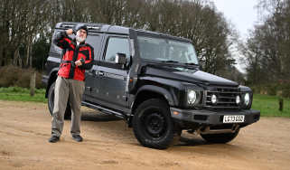 Auto Express senior test editor Dean Gibson lifting dumbells while standing next to the Ineos Grenadier