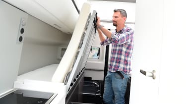 Auto Express deputy executive editor Matt Robinson adjusting Volkswagen Grand California foldaway bed