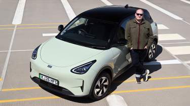 New Geely EX2 - front, car being stood next to by Auto Express news reporter Ellis Hyde