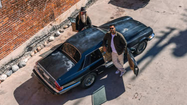 Ariel photo ofMagnus Walker and Khyzyl Saleem standing next to a Jaguar XJS