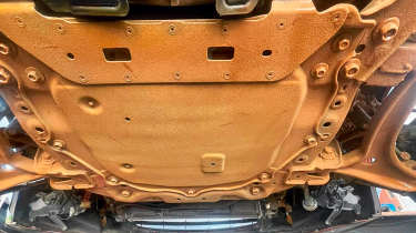 Rustbuster Full Hot Fog Treatment - rusty underside of a Mazda