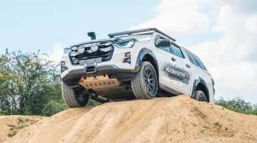 Muddied Isuzu D-Max Mudmaster - traversing hill