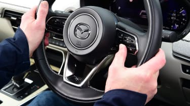 Auto Express chief sub-editor Andy Pringle operating Mazda CX-60 steering wheel controls