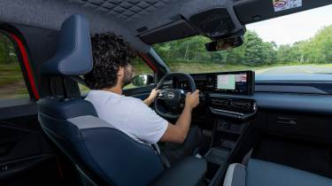Auto Express senior staff writer Jordan Katsianis driving the Nissan Micra EV (interior)