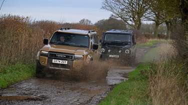 Toyota Land Cruiser and Ineos Grenadier - front action through mud