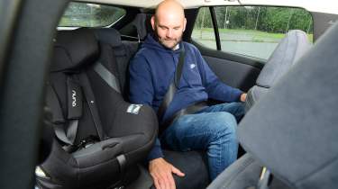 Auto Express creative director Darren Wilson sitting in the Lexus RZ's rear seat
