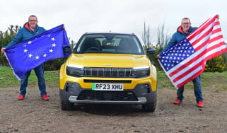 Auto Express editor-at-large John McIlroy holding an EU and US flag while standing next to the Jeep Avenger