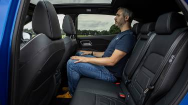 Auto Express deputy editor Richard Ingram sitting in the Nissan Qashqai e-Power N-Design&#039;s back seat