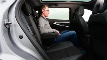 Auto Express associate editor Sean Carson testing the rear seats in the Renault Austral