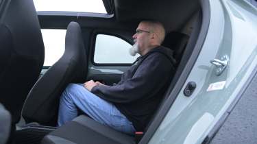 Toyota Aygo X testing in the UK - rear seats being sat in by Auto Express senior test editor Dean Gibson