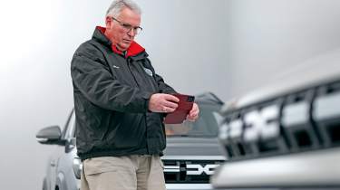 Dacia owner taking a photo of the Dacia Duster&#039;s grille