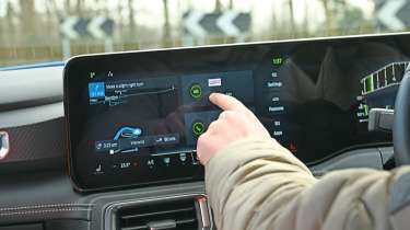 Auto Express senior content editor Shane Wilkinson operating the Ford Mustang&#039;s infotainment system