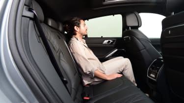 Auto Express senior staff writer Jordan Katsianis sitting in the BMW X6 xDrive40i&#039;s back seat