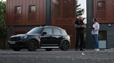 Auto Express consumer reporter Tom Jervis talking to PC Mark Jones outside Wilmslow police station