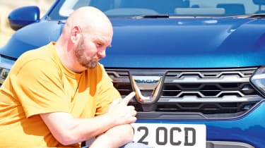 Dacia Jogger long termer - pointing at Dacia badge