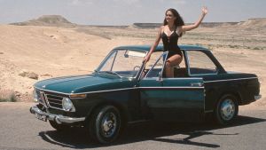Model posing with BMW 02 Series