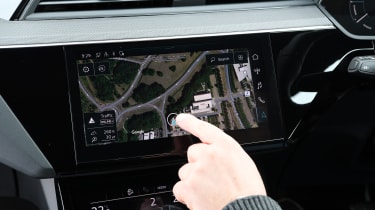 Auto Express chief reviewer Alex Ingram operating Audi Q8 navigation system