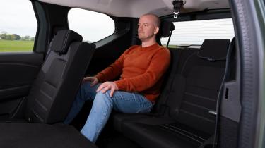 Auto Express chief reviewer Alex Ingram sitting in the Dacia Jogger&#039;s third row seat