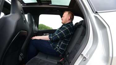 Auto Express news reporter Ellis Hyde sitting in the BMW iX1&#039;s back seat