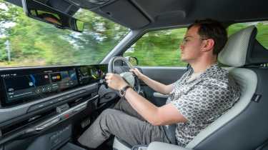 Kia EV2 Long Range - front interior, car being driven by Auto Express consumer reporter Tom Jervis