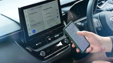 Auto Express current affairs and features editor Chris Rosamond connecting smartphone to Toyota Corolla infotainment system