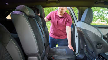 Auto Express news reporter Ellis Hyde adjusting the Peugeot E-5008&#039;s middle row seats