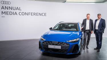 Audi executives standing next to an Audi A6 Avant