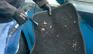 Laser Tools Compact Swirl Gun being used to clean a car mat