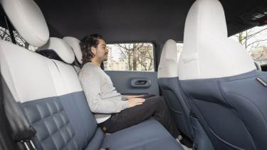 Fiat Grande Panda La Prima - rear seats being sat in by Auto Express senior staff writer Jordan Katsianis 