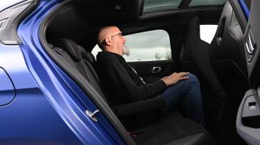 Auto Express senior road test editor Dean Gibson sitting in the BMW M135&#039;s back seaa