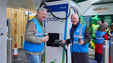 Chris Rosamond and Richard Bartlett standing next to a BP Pulse charger