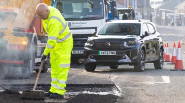 Pothole repair taking place with Citroen in the background