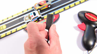 Auto Express product tester inspecting slot car set connectors