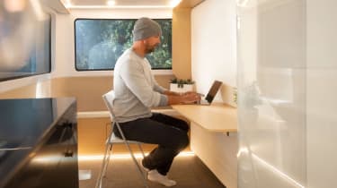 Person working at a desk in the Pebble Flow caravan