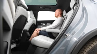 Auto Express chief reviewer Alex Ingram sitting in the Polestar 2&#039;s rear seats