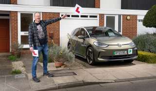 Auto Express chief sub-editor Andy Pringle holding two L-plates while standing next to the Volkswagen ID.3