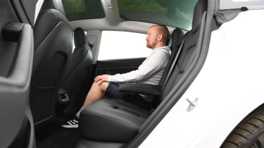 Auto Express chief reviewer Alex Ingram sitting in the Tesla Model 3&#039;s rear seats