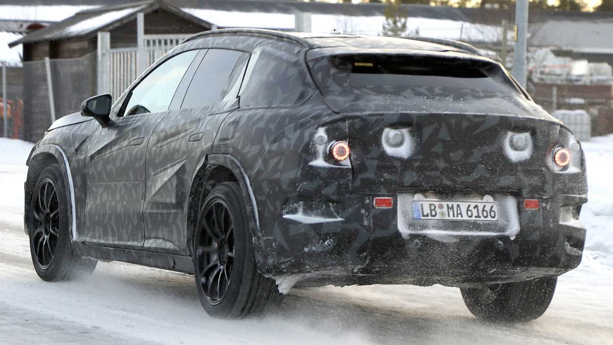 Rear three quarter angle of the camouflaged Mercedes-AMG electric SUV during cold weather testing