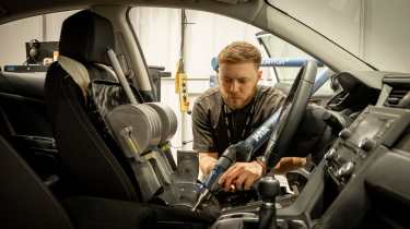 Horiba Mira technician preparing a car&#039;s interior for crash testing