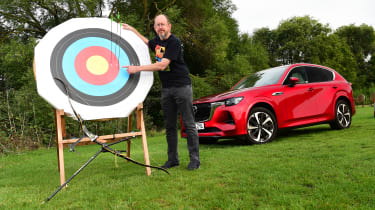 Auto Express chief sub-editor Andy Pringle standing next to an archery target