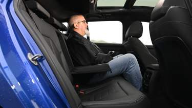 Auto Express senior road test editor Dean Gibson sitting in the BMW 3 Series Touring&#039;s back seat