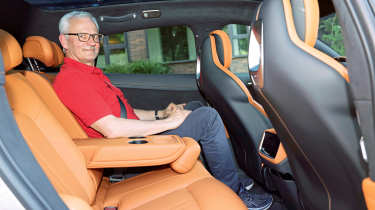 Dirk Branke sitting in the Xiaomi YU7&#039;s rear seat