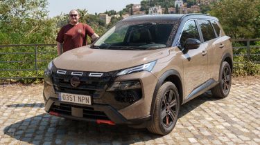 Auto Express news repoter Ellis Hyde standing next to the Nissan X-Trail
