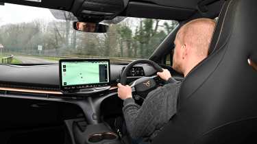 Cupra Tavascan – interior driving shot with Auto Express Chief reviewer, Alex Ingram