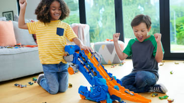 Children playing with Hot Wheels City Ultimate Hauler set