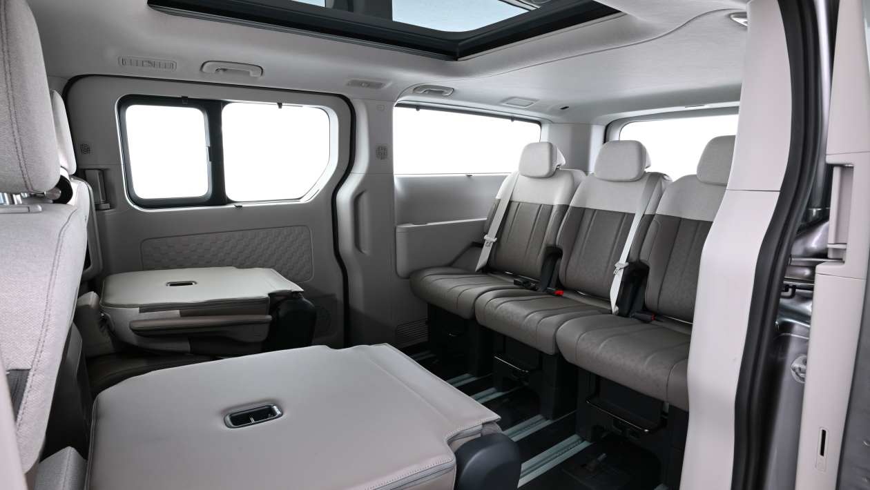 Kia PV7 Passenger rear cabin with seating and table